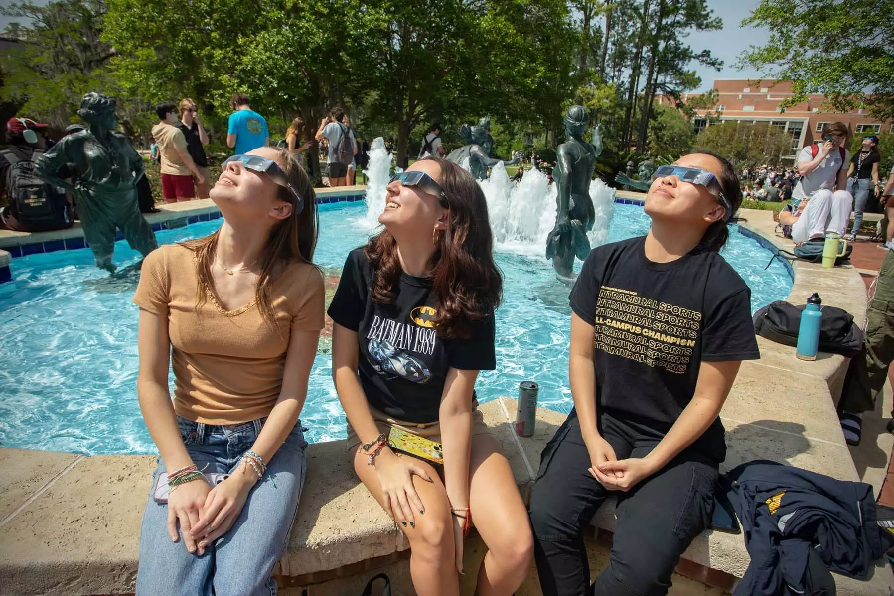 Students in glasses gaze toward the sky as Tallahassee witnesses a partial solar eclipse April 8, 2024.