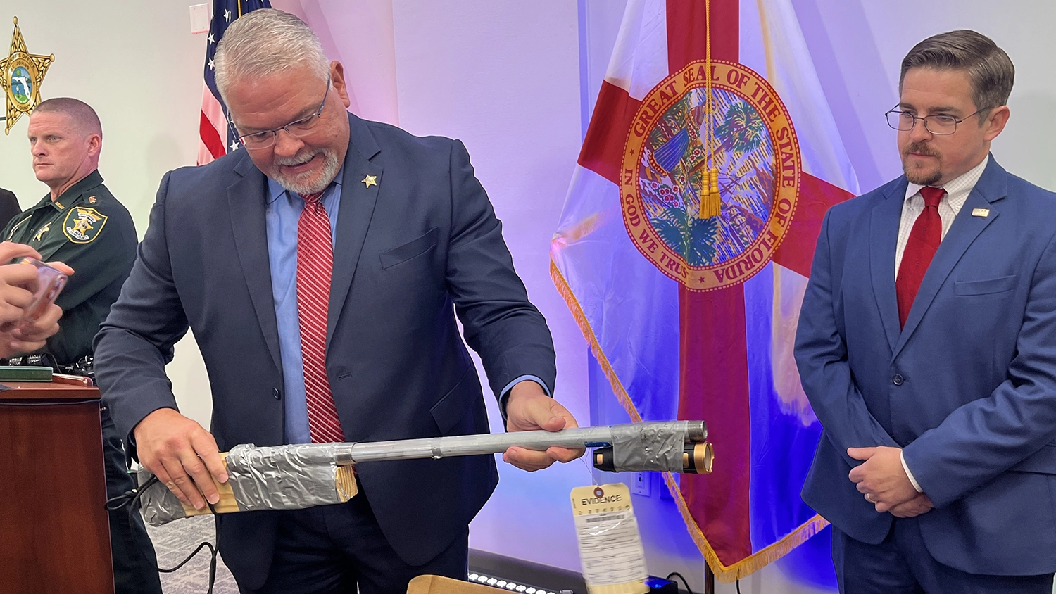 Sgt. Gene Tolbert with the St. Johns County Sheriff's Office demonstrates a makeshift gun confiscated during an investigation into two local teenagers. The gun, made of piping and wood, was part of a cache that included other makeshift firearms and explosive material.