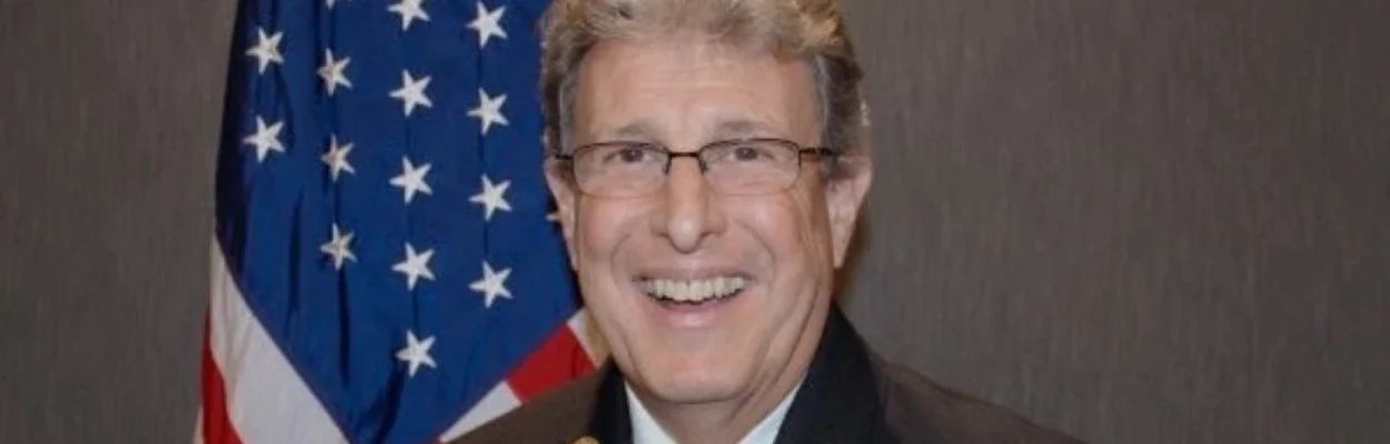 Portrait of Fire-Rescue Chief Lorin Mock, posing in front of an American flag.