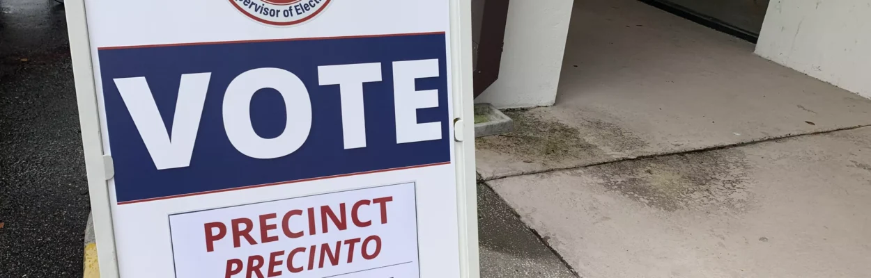 A Vote placard in front of a precinct building.