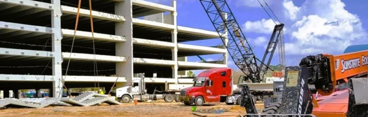 A construction crane works on a parking garage under construction at Jacksonville International Airport.