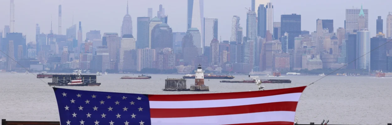 A view of the New York skyline with an American flag in the foreground to commemorate the 9/11 attacks.