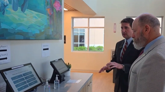 St. Johns County Clerk of Court Brandon Patty shows County Commission Chair Clay Murphy around the new public service center in St. Augustine.