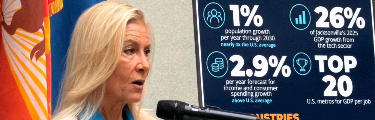 Mayor Donna Deegan stands at a microphone, speaking about the Oxford Economics ranking.