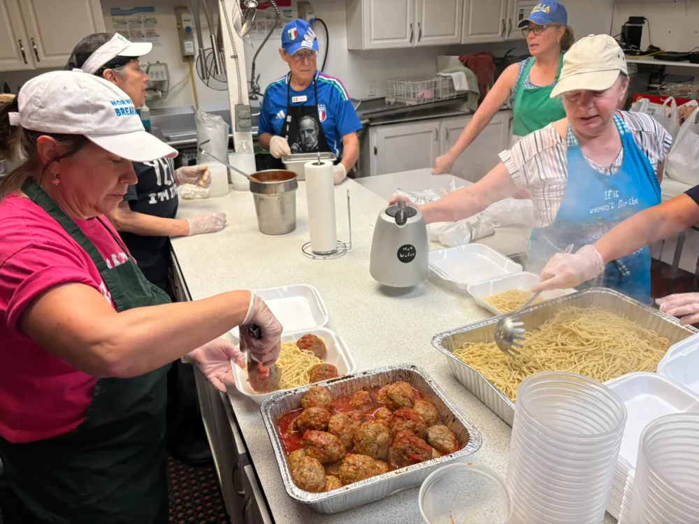 Members of the Italian American Club of Jacksonville preparing their popular spaghetti dinner
