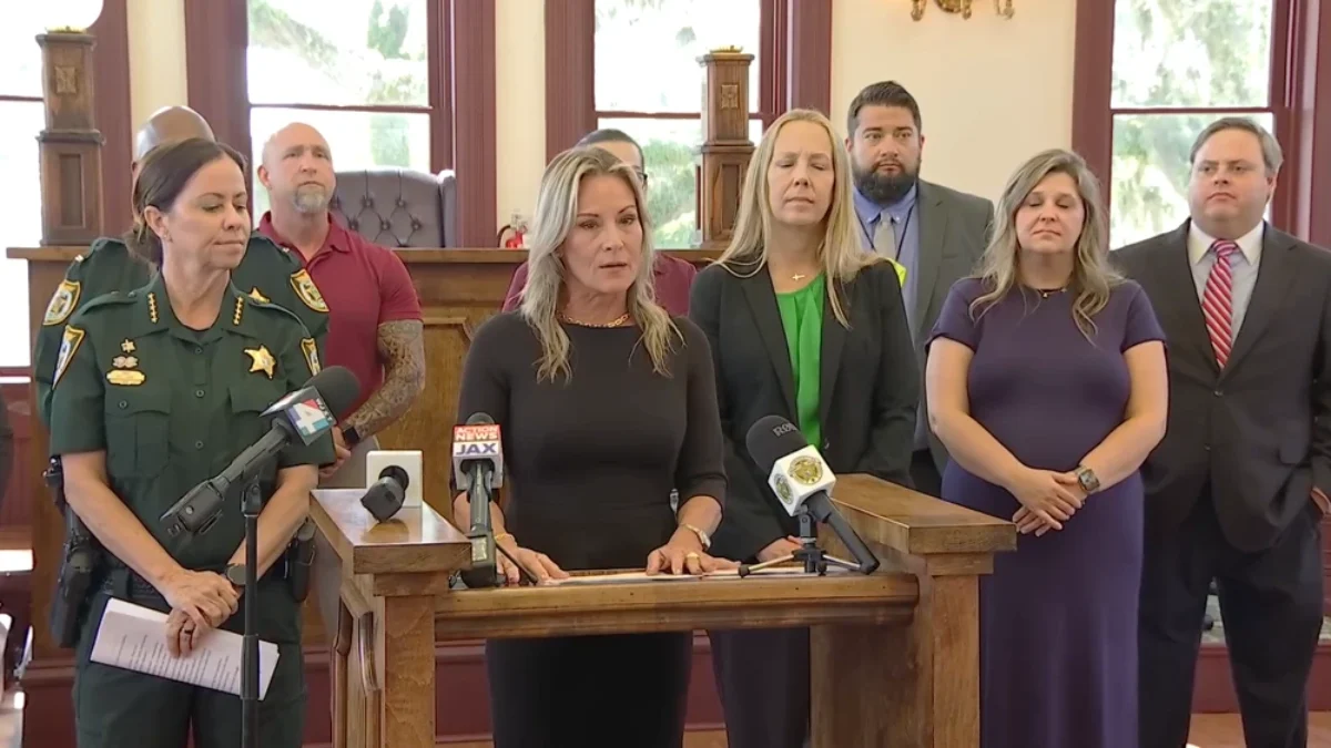 Clay County official stand in a line at a news conference, announcing a task force to target exploitive guardians.
