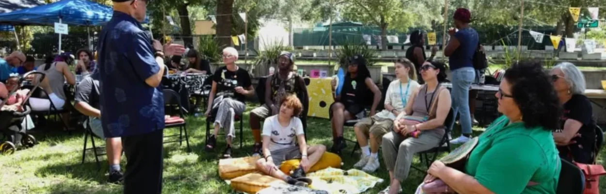 People sit in a circle at a previous Evidence of Life event and listen to Rodney L. Hurst Sr. speak