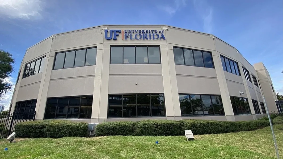 A tan building with the University of Florida logo on the top
