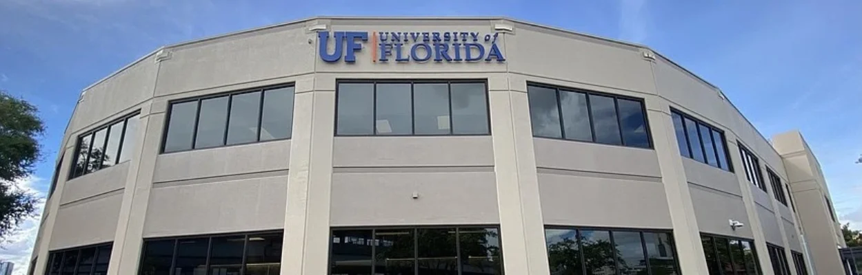 A tan building with the University of Florida logo on the top