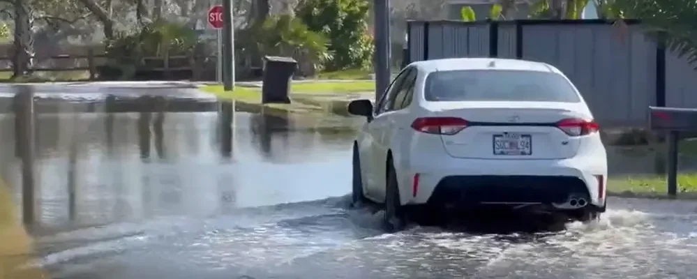 A car plows through a swamped street in St. Augustine.