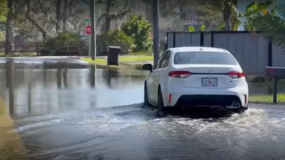 A car plows through a swamped street in St. Augustine.