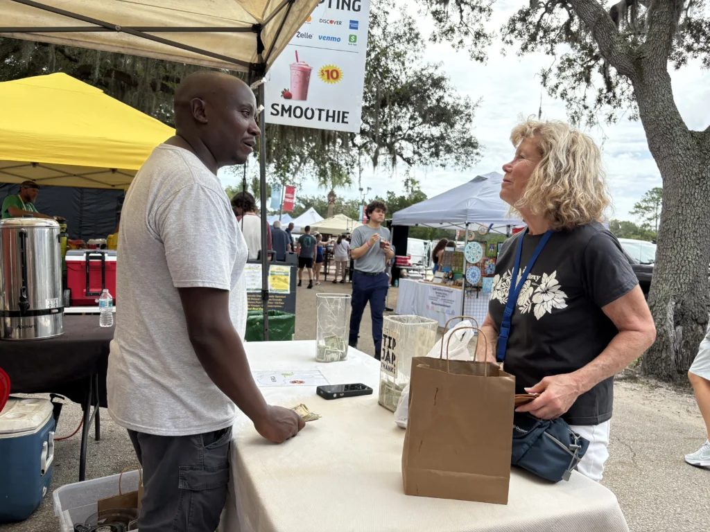 Suzanne D'Armond talking with Martin Kakabi