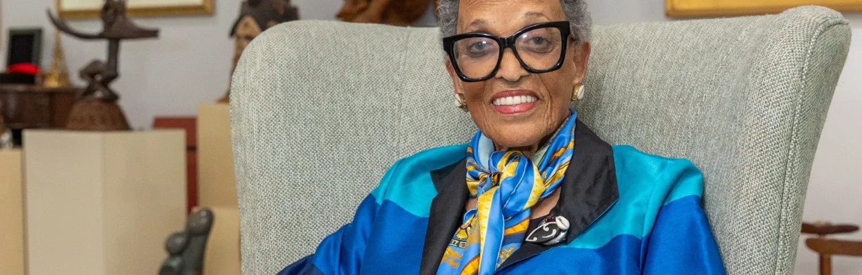 Dr. Johnnetta Betsch Cole wears a blue blazer and black pants inside her American Beach home.