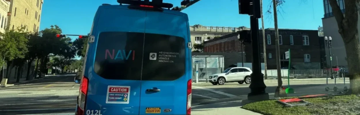 One of JTA's NAVI autonomous shuttles waits to turn right onto Bay Street.