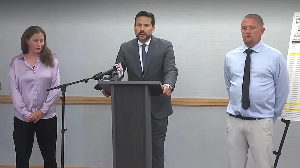 Family stands at side of attorney after suing apartment complex.