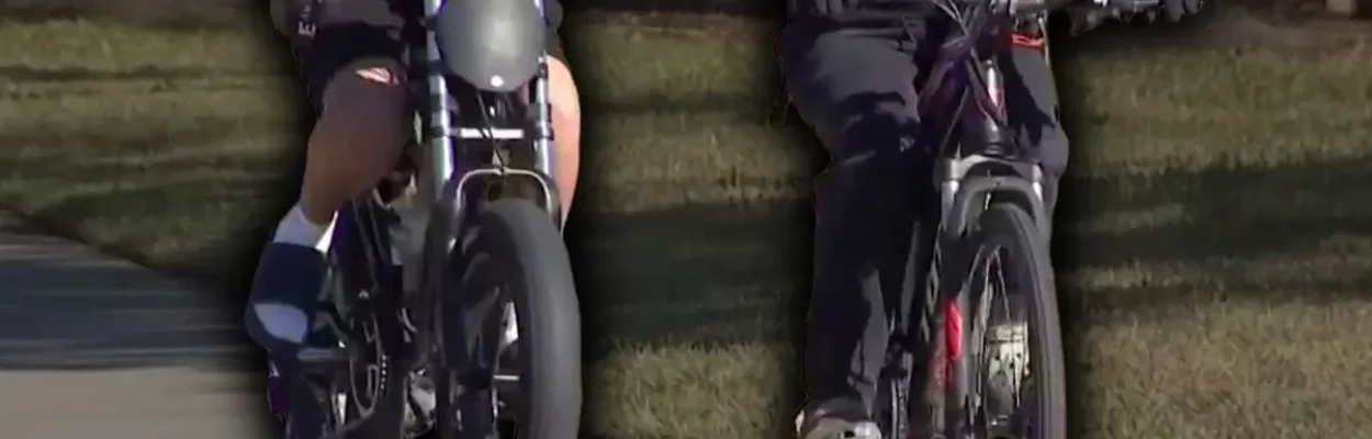 Two people ride e-bikes on a path.
